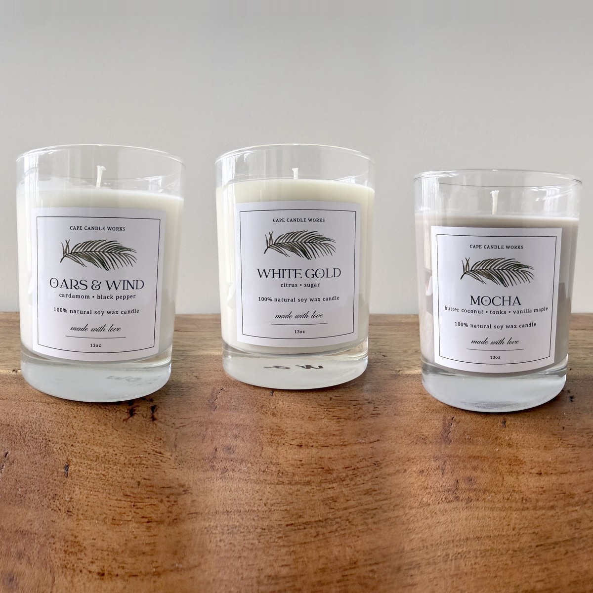 Oars & Wind, White Gold and Mocha soy candles on a wood table